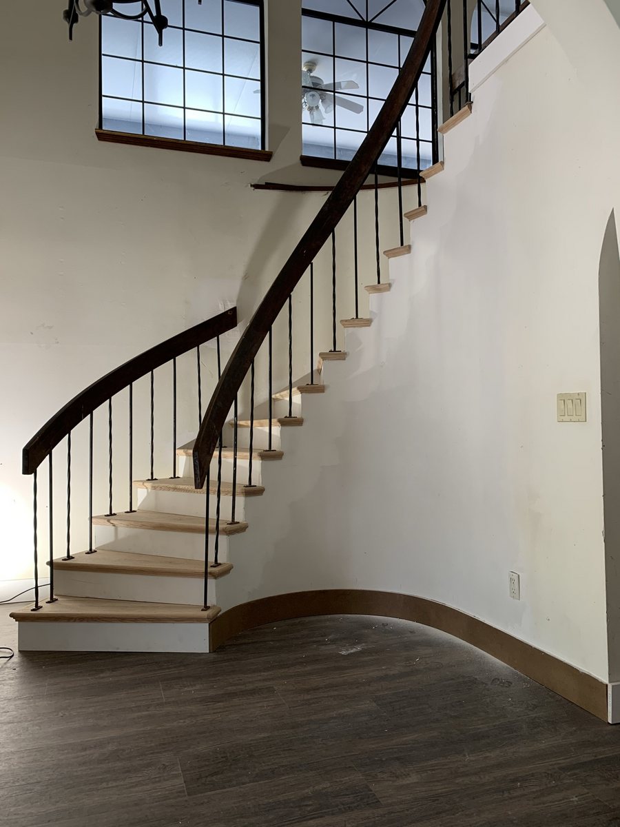 Curved staircase with new wood treads installed by KM Property Maintenance
